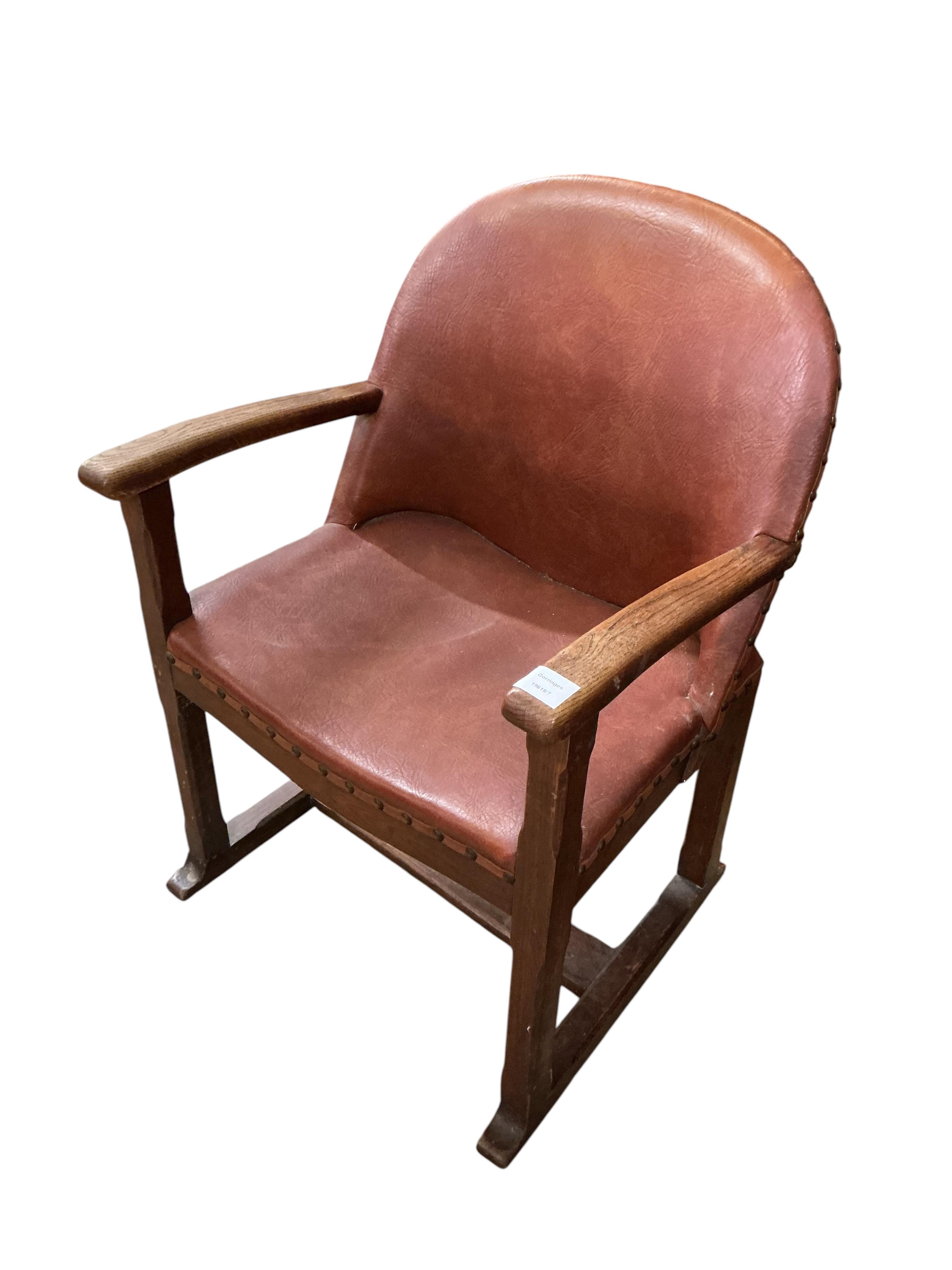 A 1920's oak Arts and Crafts leather upholstered desk chair, width 57cm, depth 42cm, height 82cm